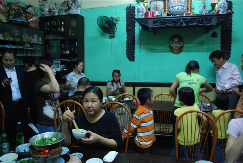 Customers enjoy La Vong grilled fish pies