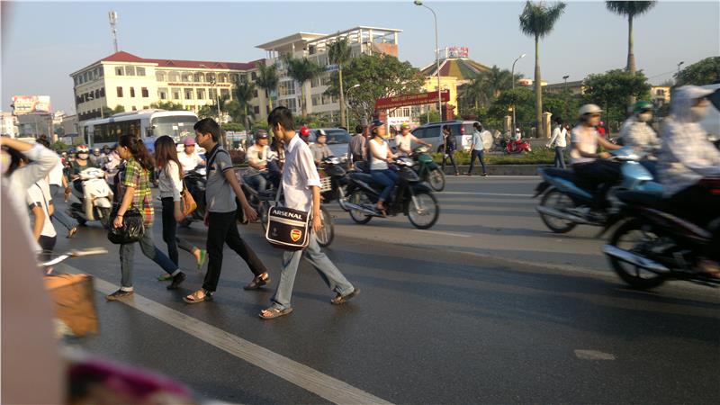 Students are crossing a street in Vietnam