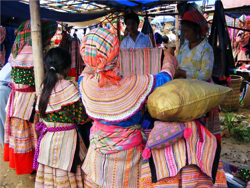 Local Bac Ha villagers shopping for more colorful clothing