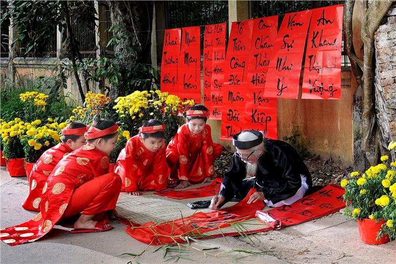 A calligraphist writes Nom characters in Tet Vietnam